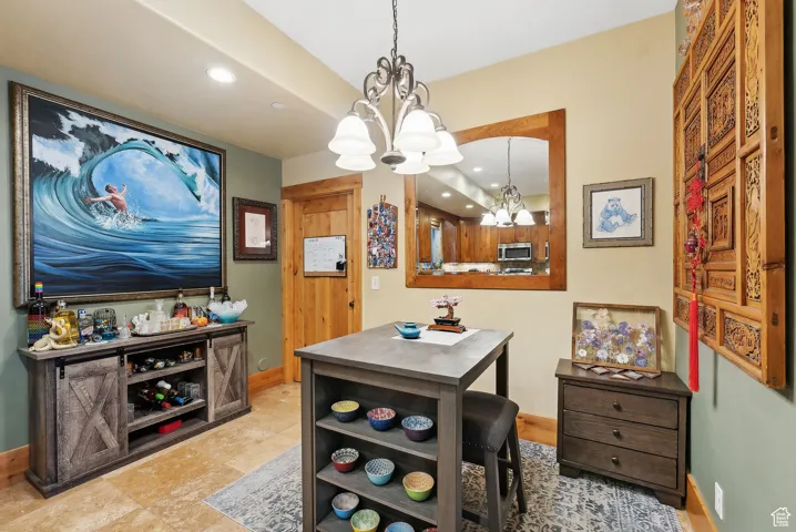 Dining room featuring a chandelier, baseboards, and recessed lighting