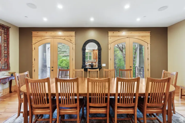 Dining room featuring french doors, plenty of natural light, light wood-style floors, and recessed lighting