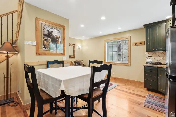Dining area with light wood-style flooring, recessed lighting, and baseboards