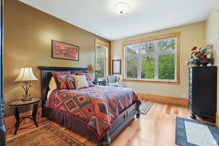 Bedroom featuring wood finished floors and baseboards