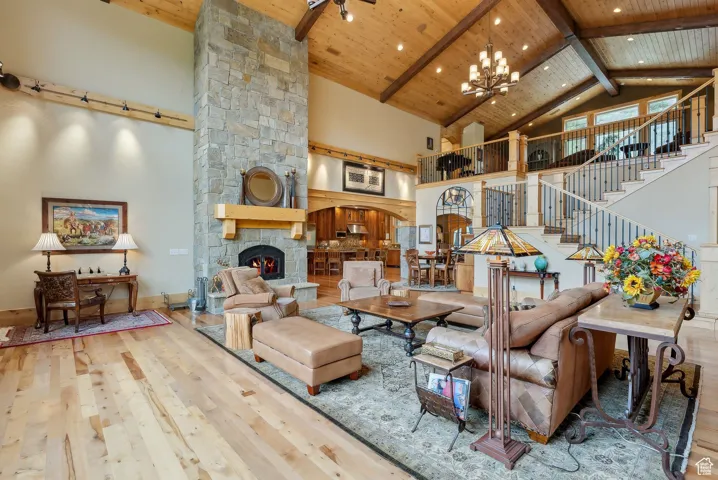 Living area featuring hardwood / wood-style flooring, high vaulted ceiling, wood ceiling, beam ceiling, and recessed lighting