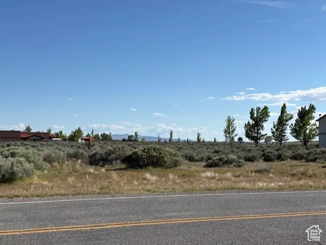 View of asphalt street featuring a view of rural / pastoral area