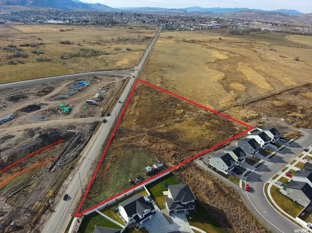 Aerial overview of property's location featuring property parcel outlined and a mountainous background