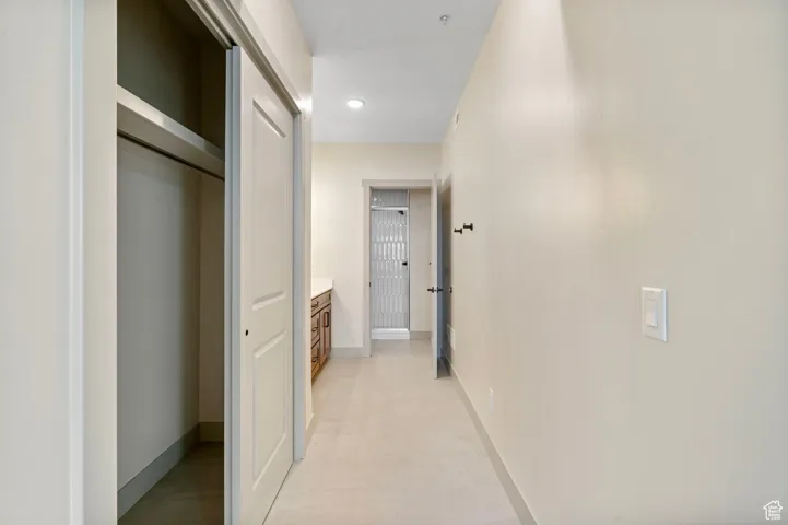 Hall featuring baseboards and recessed lighting