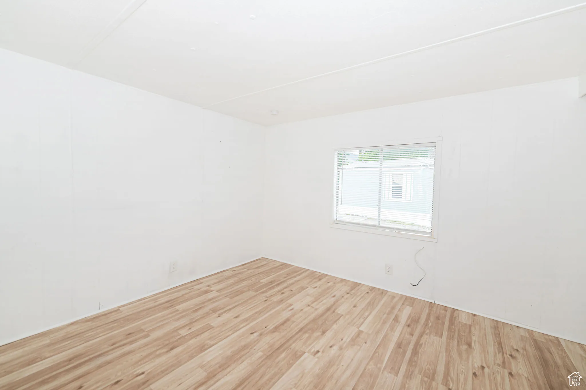 Unfurnished room with wood finished floors