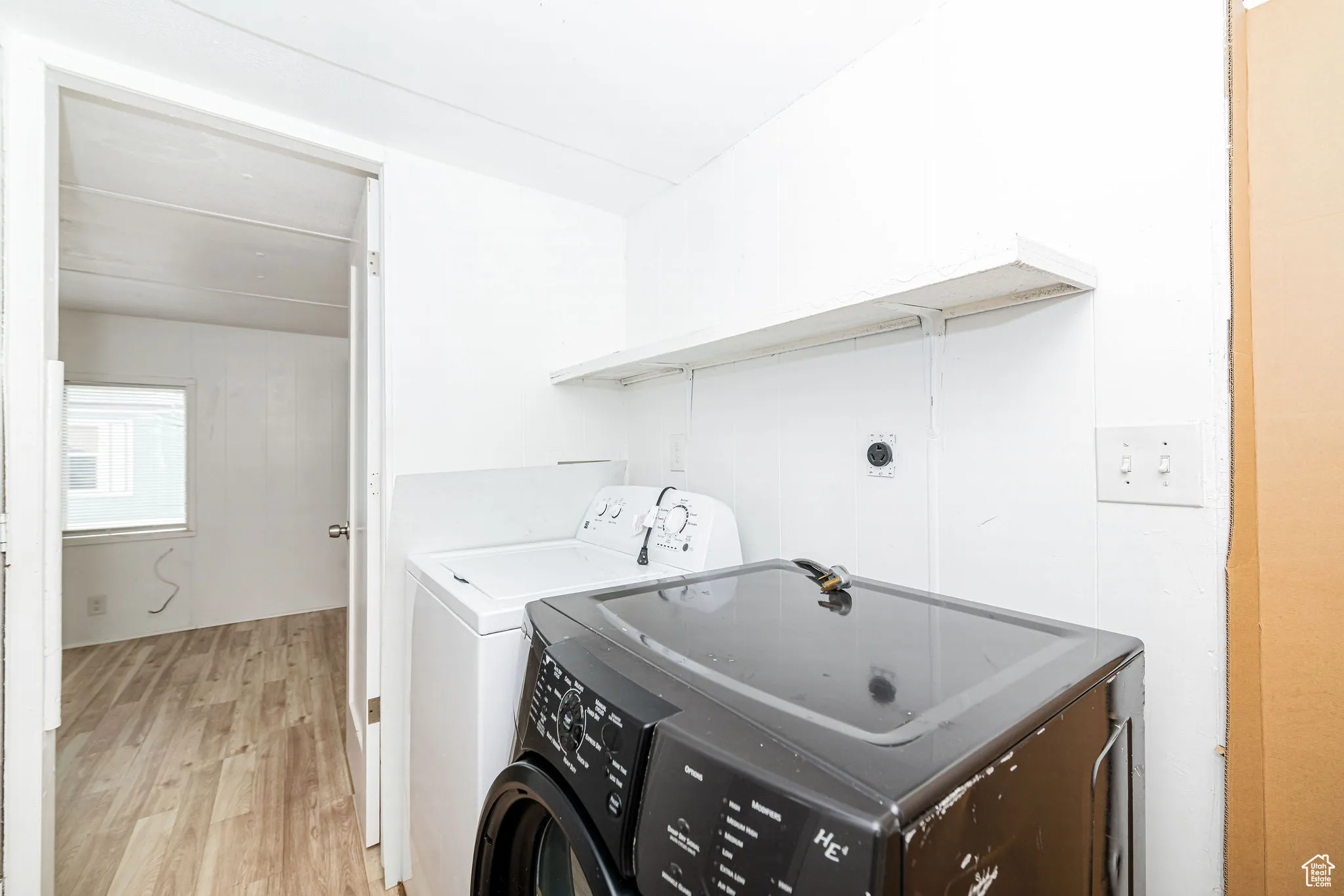 Washroom featuring washer and clothes dryer and light wood finished floors