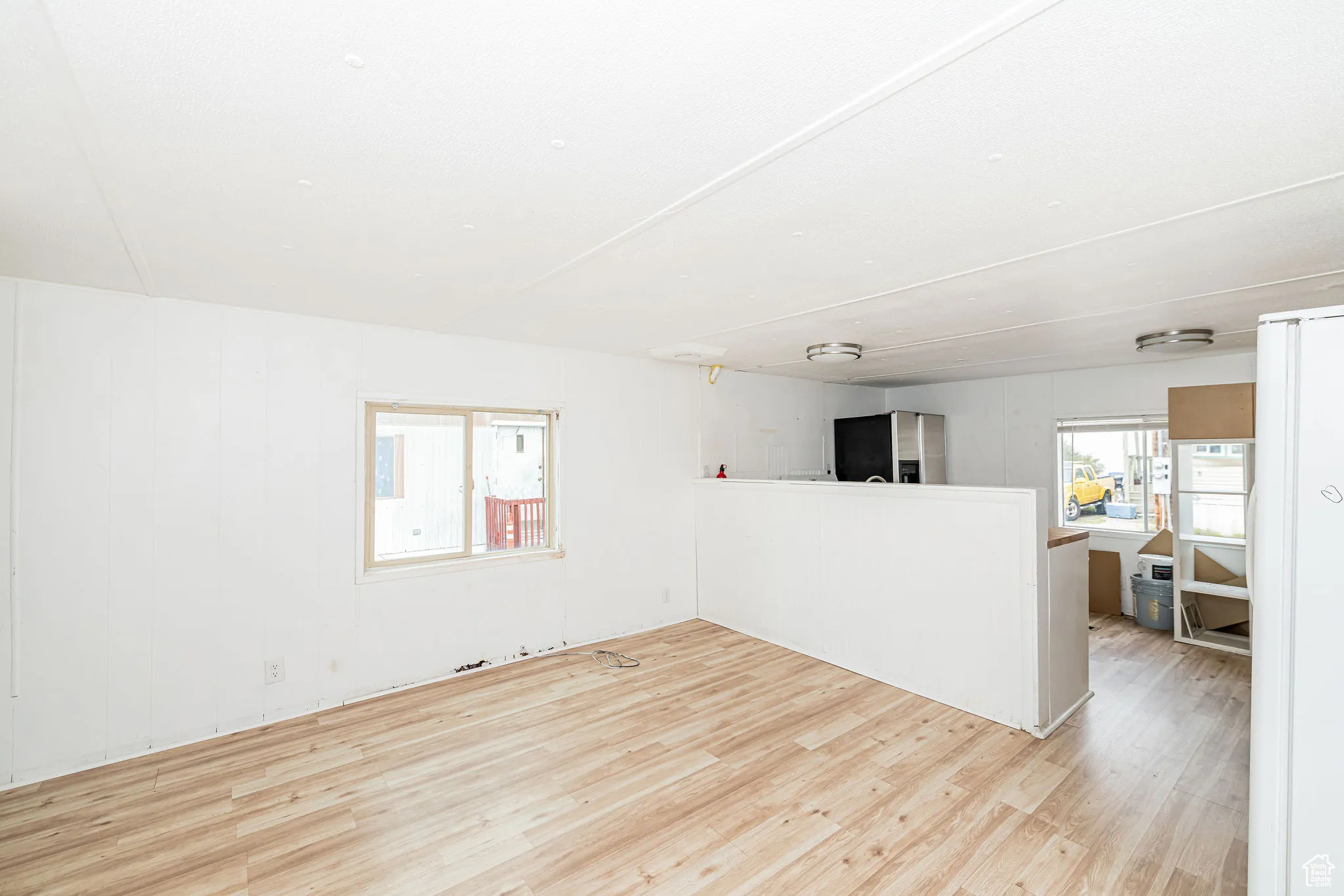 Unfurnished living room featuring wood finished floors
