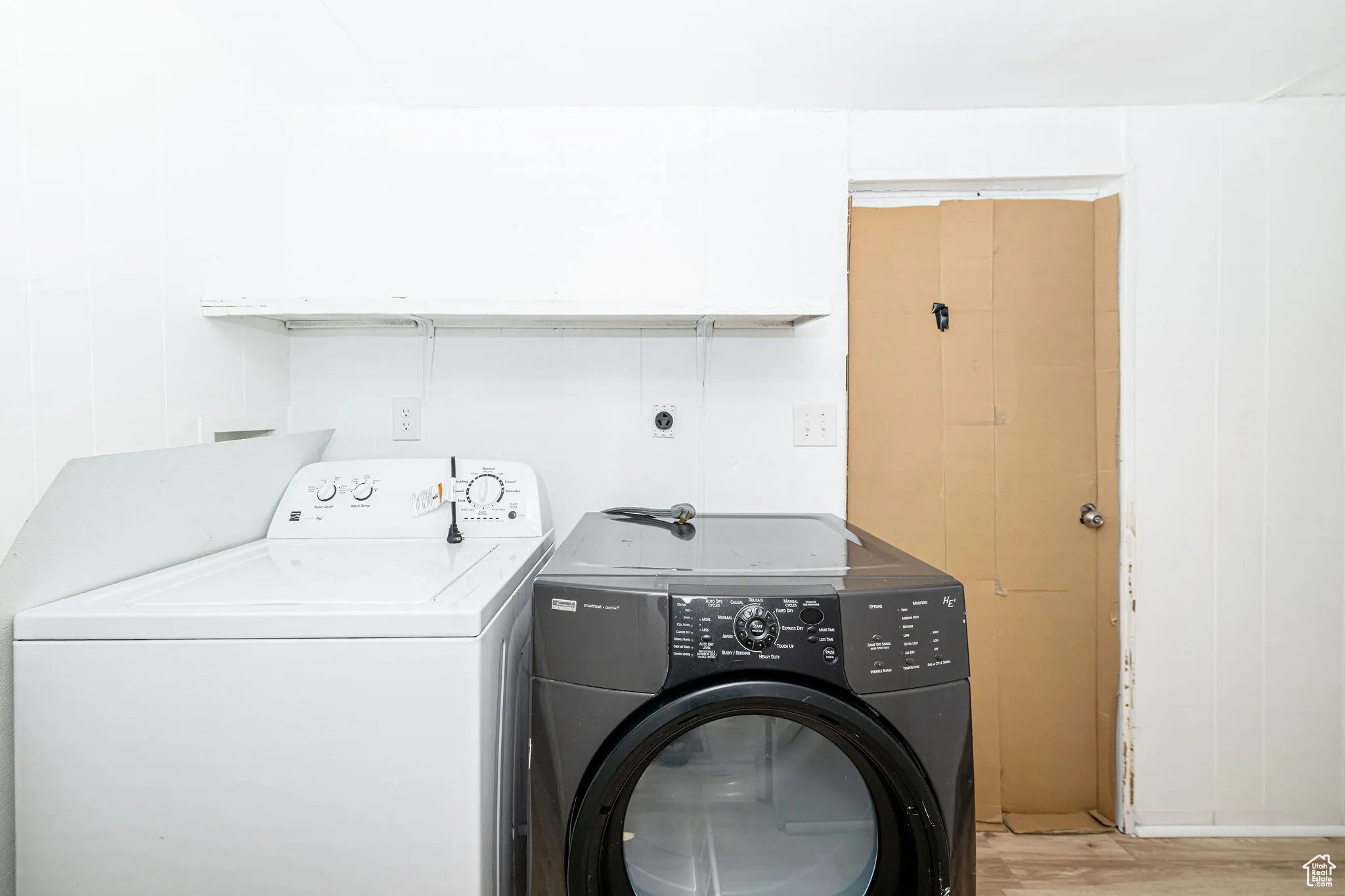 Washroom with washer and dryer and light wood-style flooring