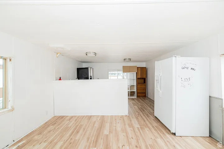 Unfurnished living room with light wood finished floors