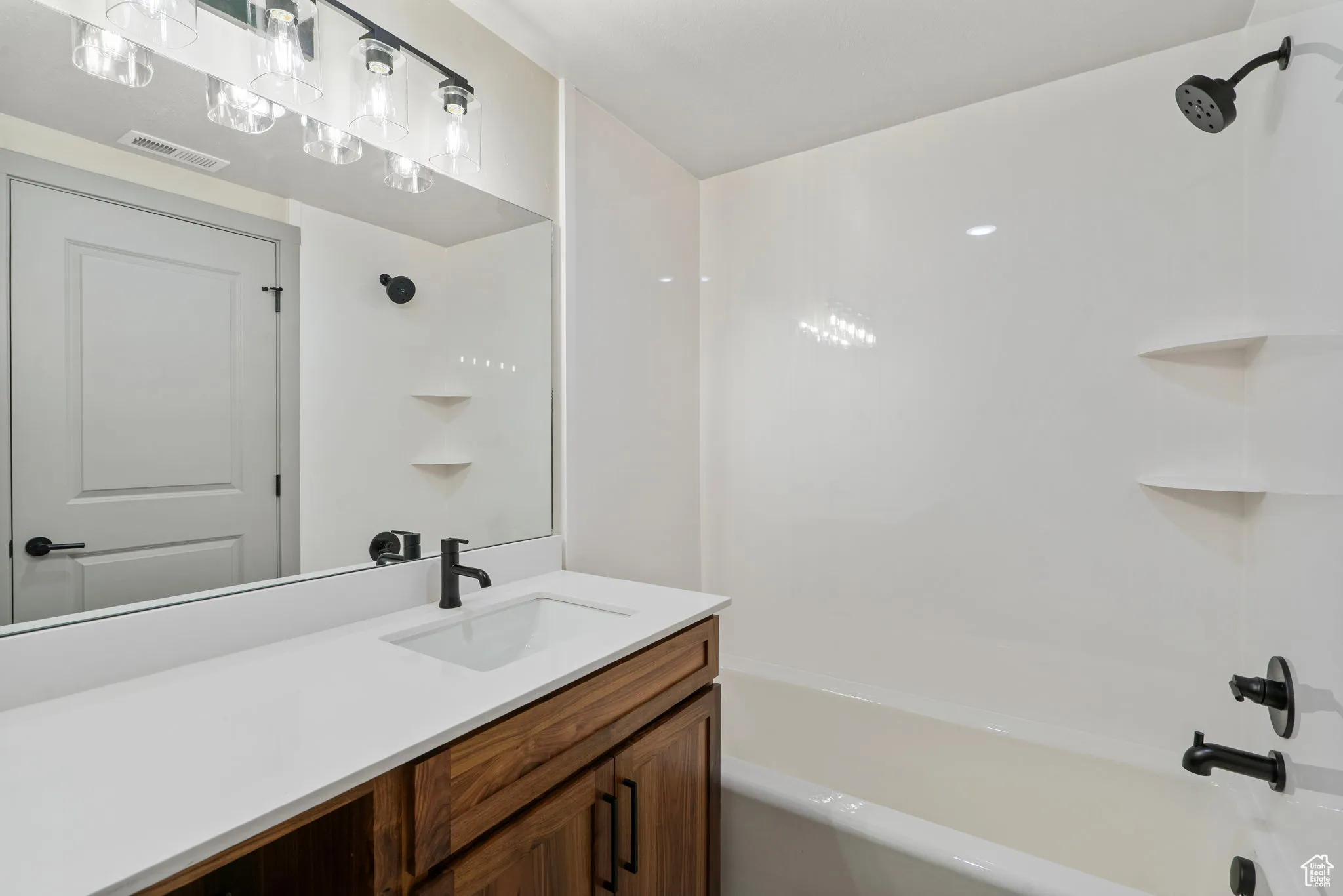 Bathroom featuring  shower combination and vanity