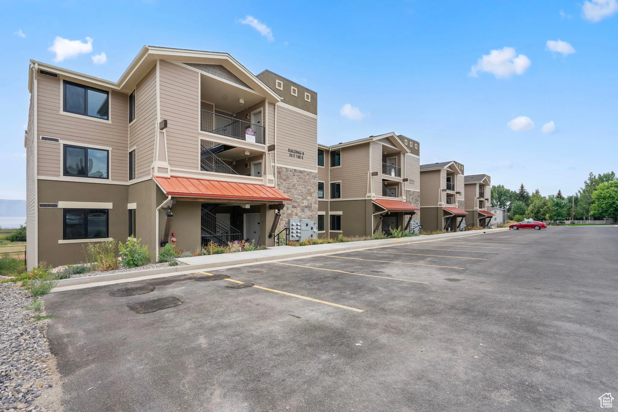 View of property featuring uncovered parking