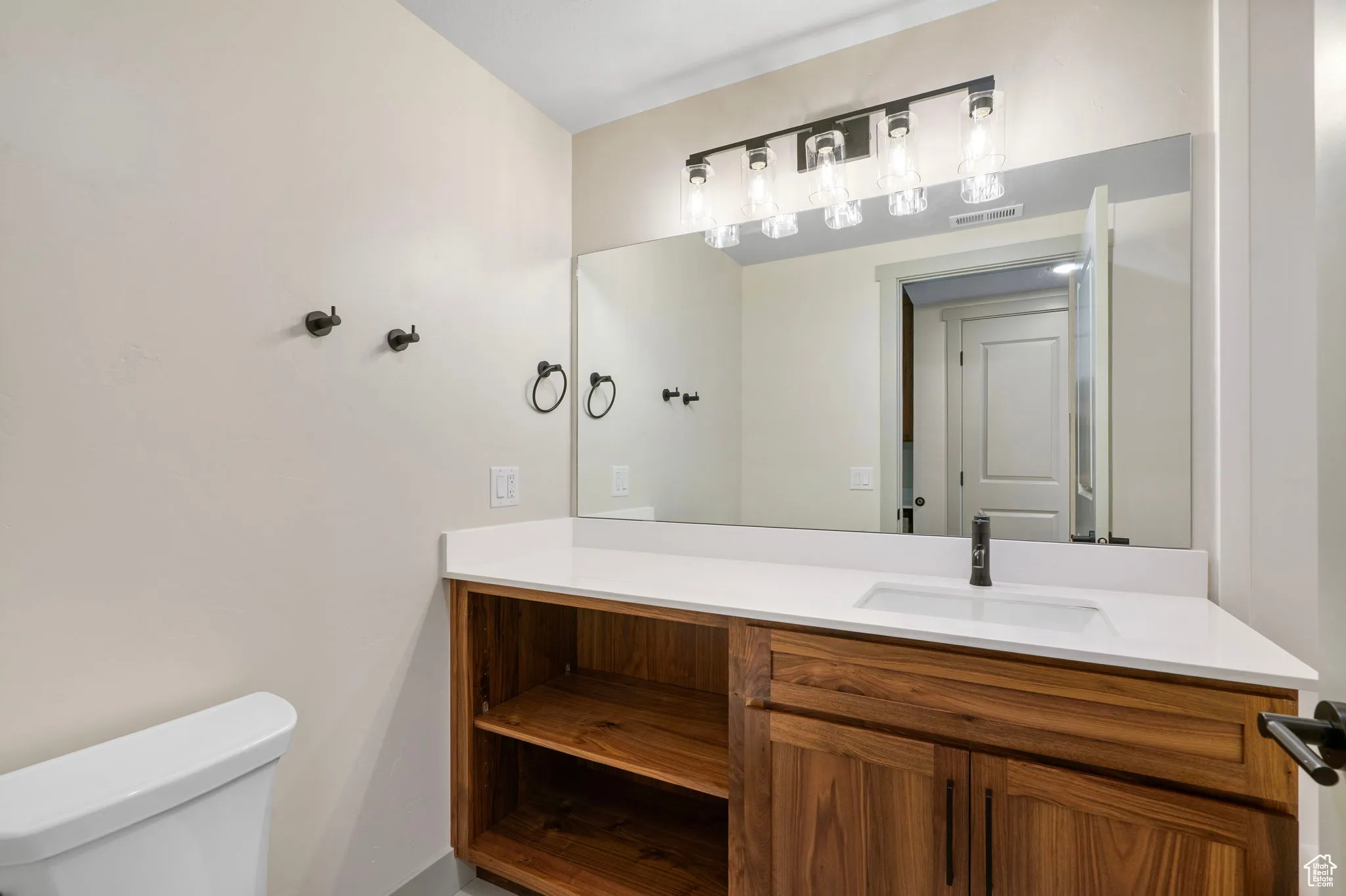 Half bath featuring vanity and toilet