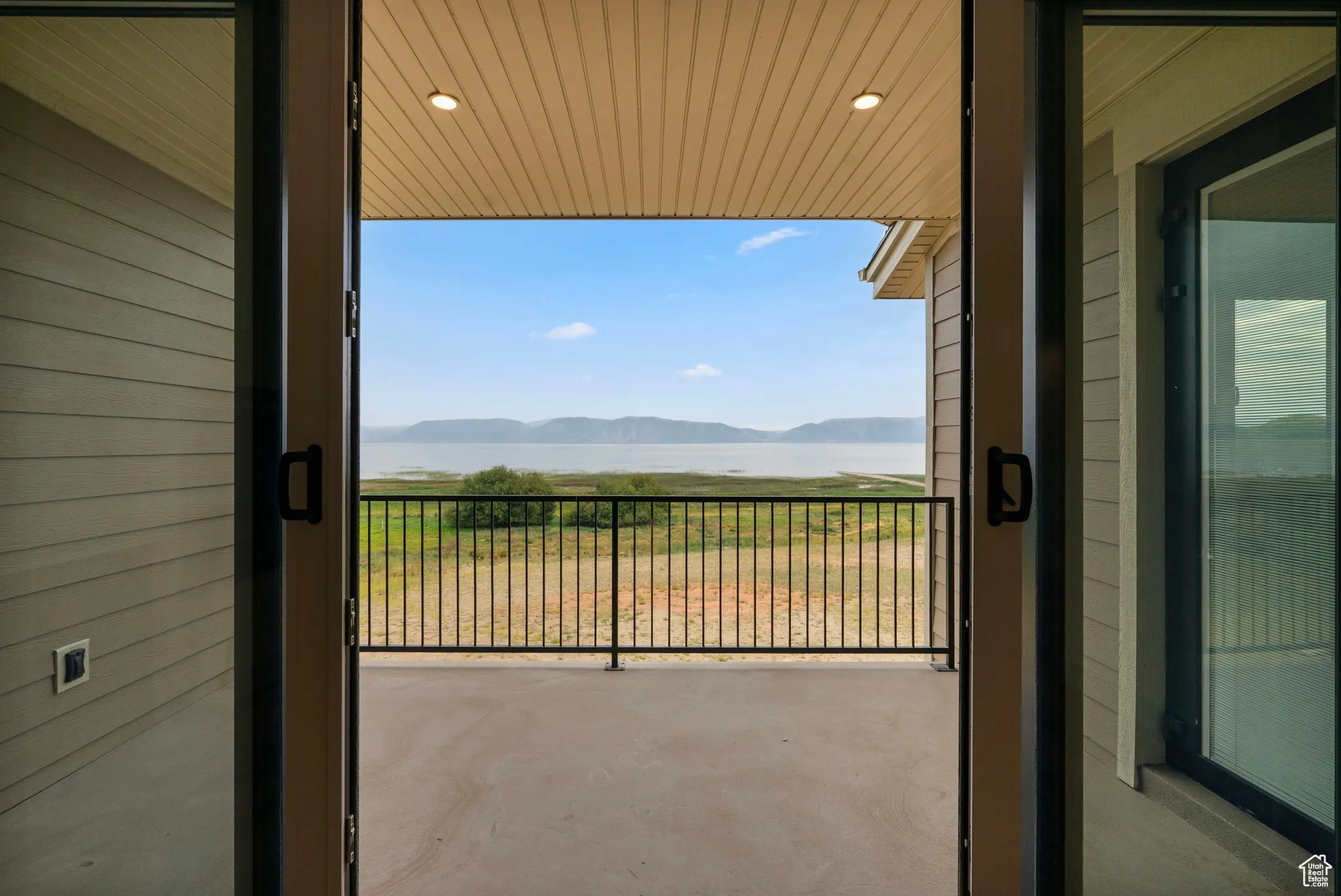Balcony featuring a water and mountain view