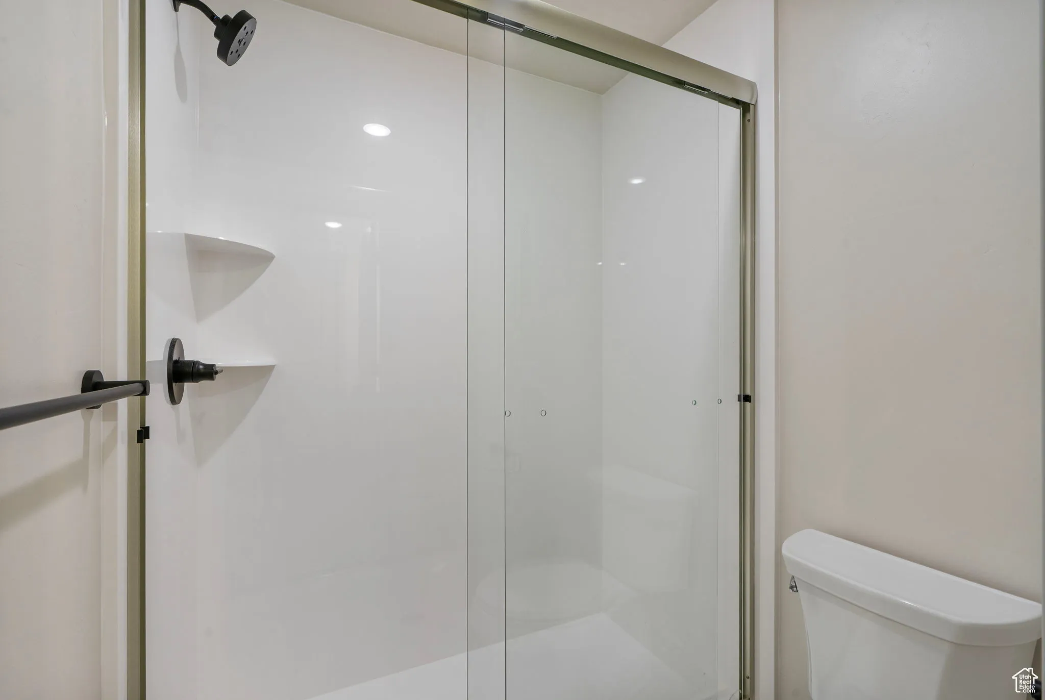 Full bathroom with a shower stall and toilet