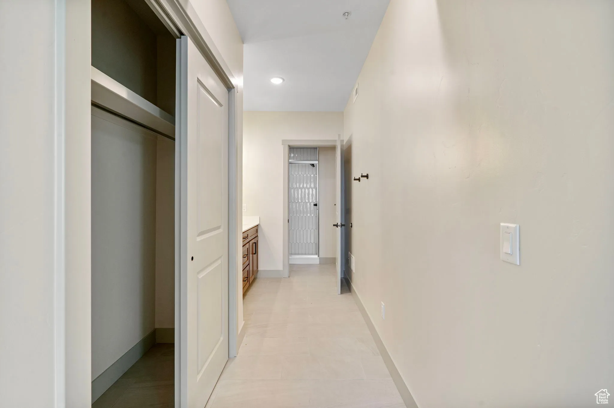 Hall featuring baseboards and recessed lighting