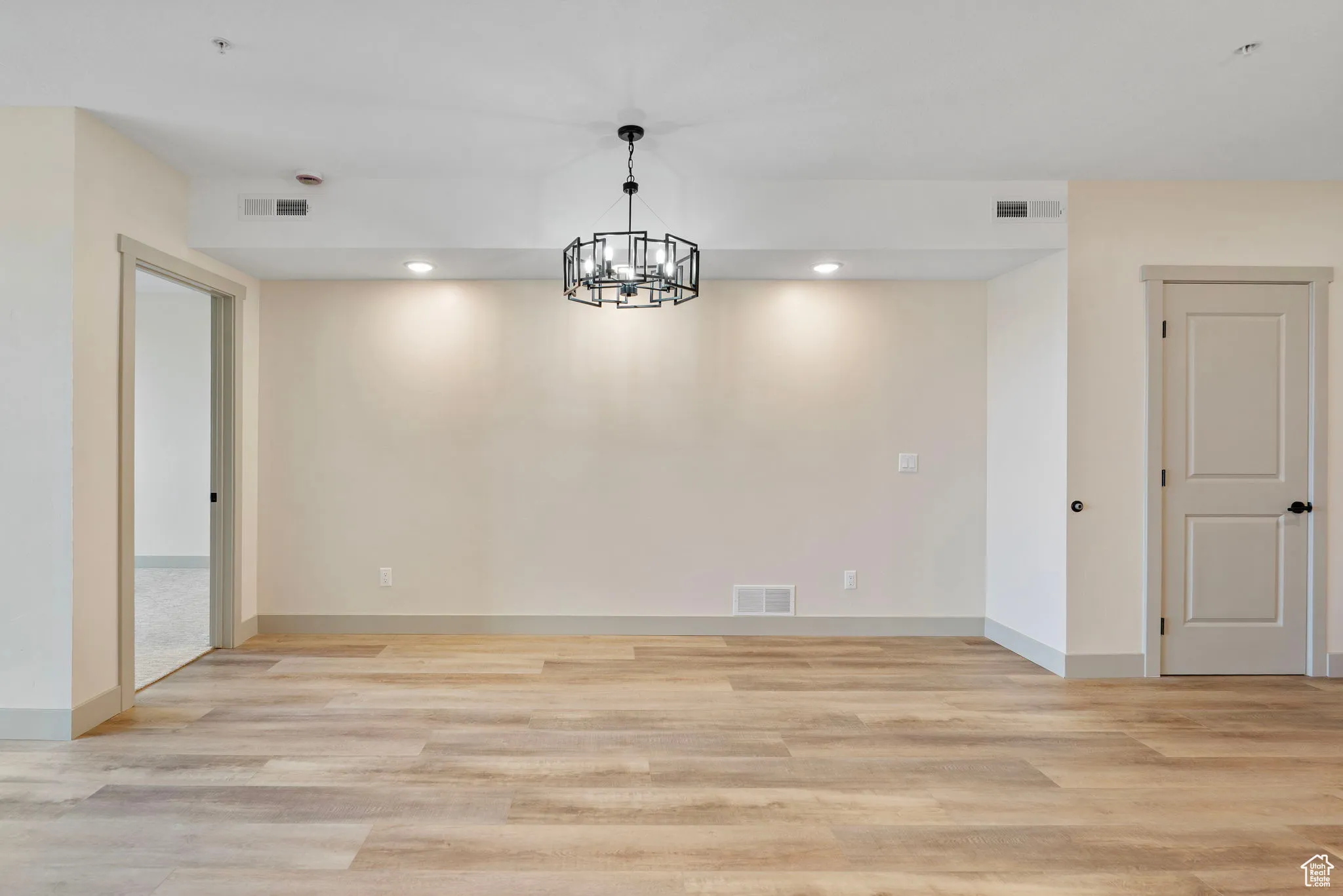 Unfurnished dining area featuring recessed lighting, light wood-type flooring, and a chandelier