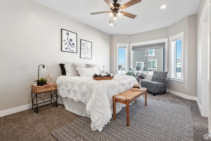 Carpeted bedroom featuring recessed lighting and a ceiling fan
