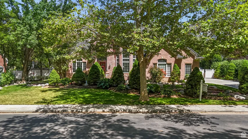 Obstructed view of property featuring brick siding