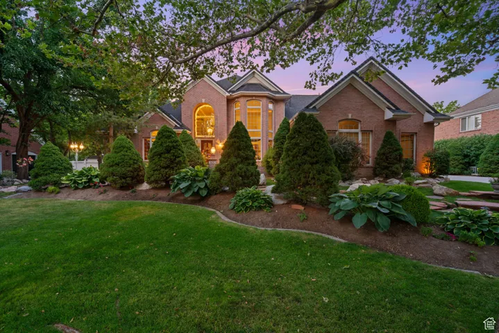 Traditional-style house featuring brick siding and a yard