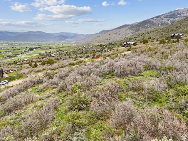 View of mountain backdrop featuring rural landscape