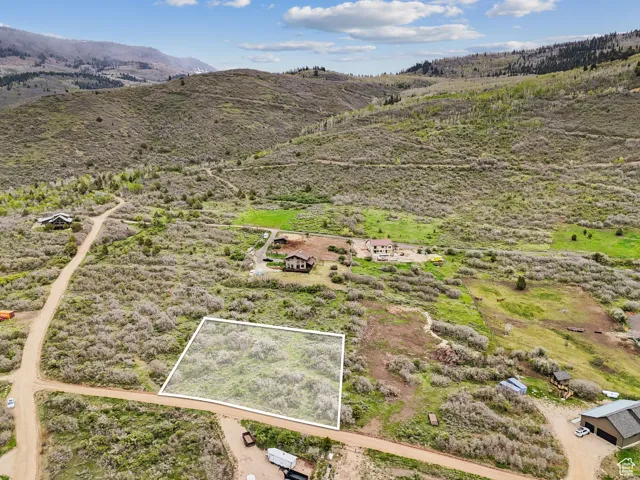 View of rural area with property parcel outlined and a mountain backdrop