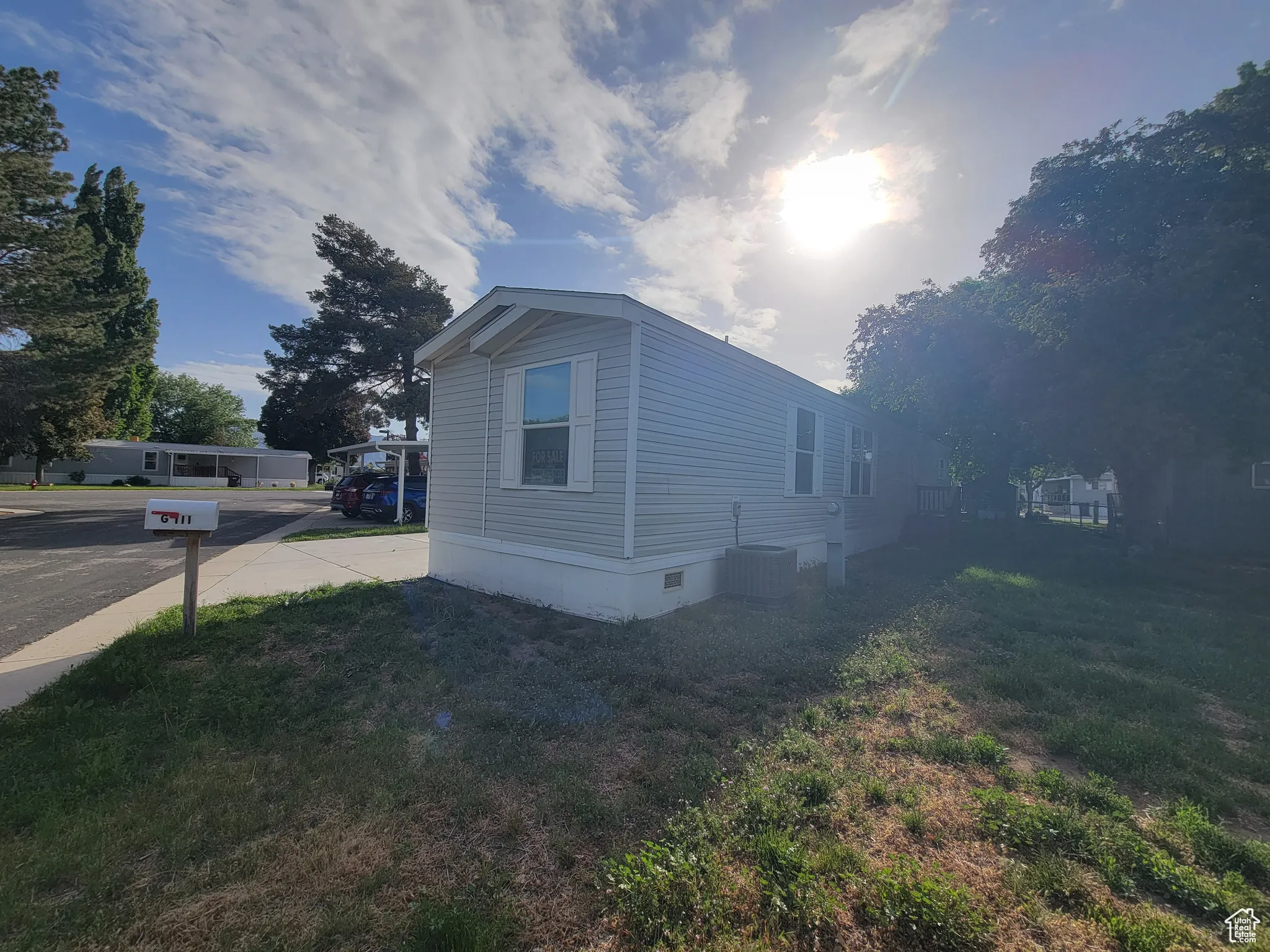 View of side of home featuring crawl space, a lawn, and central air condition unit