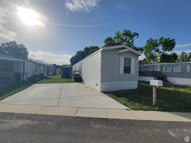 View of front of property with a front yard and crawl space