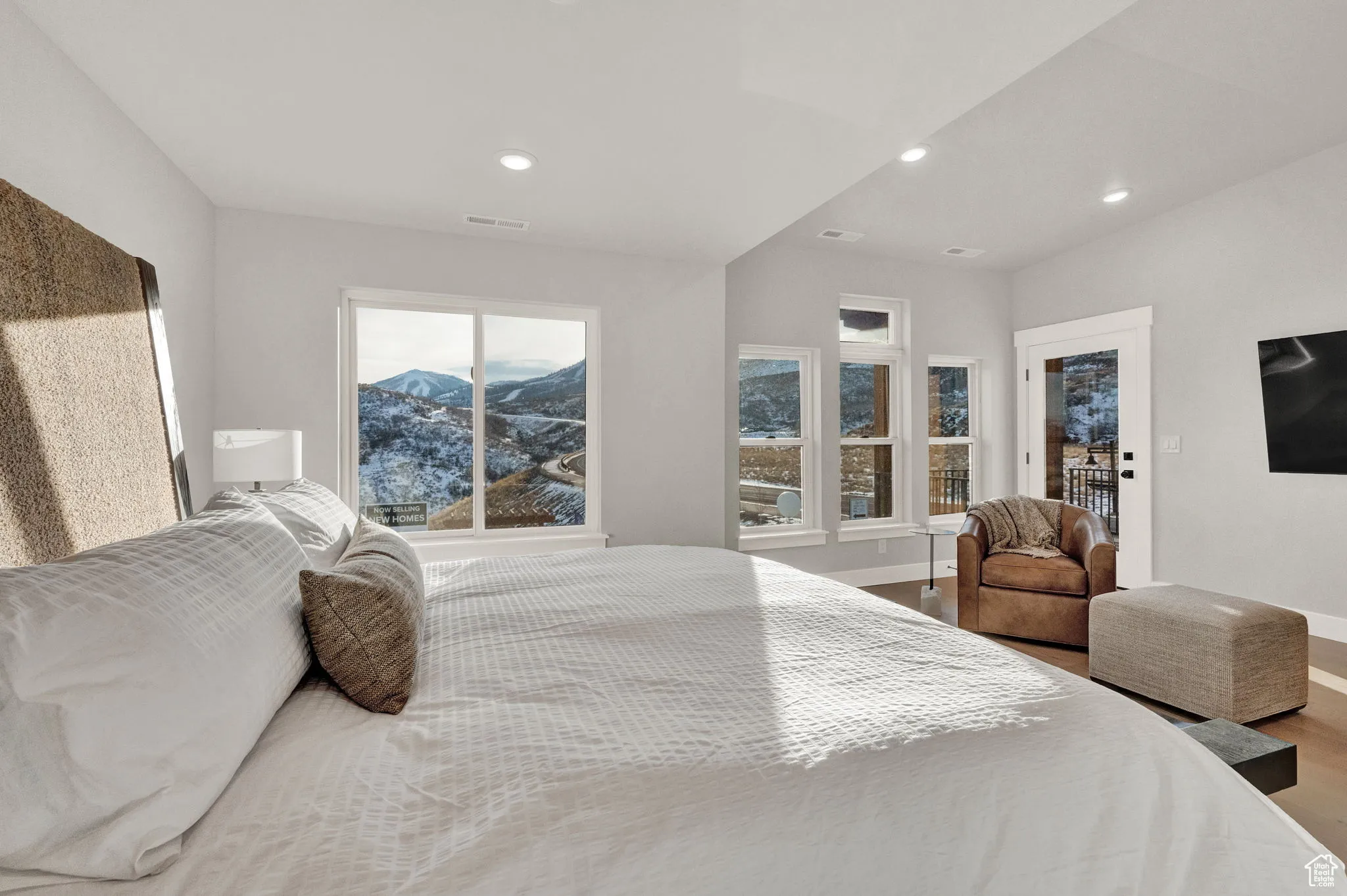 Bedroom featuring baseboards, wood finished floors, and recessed lighting