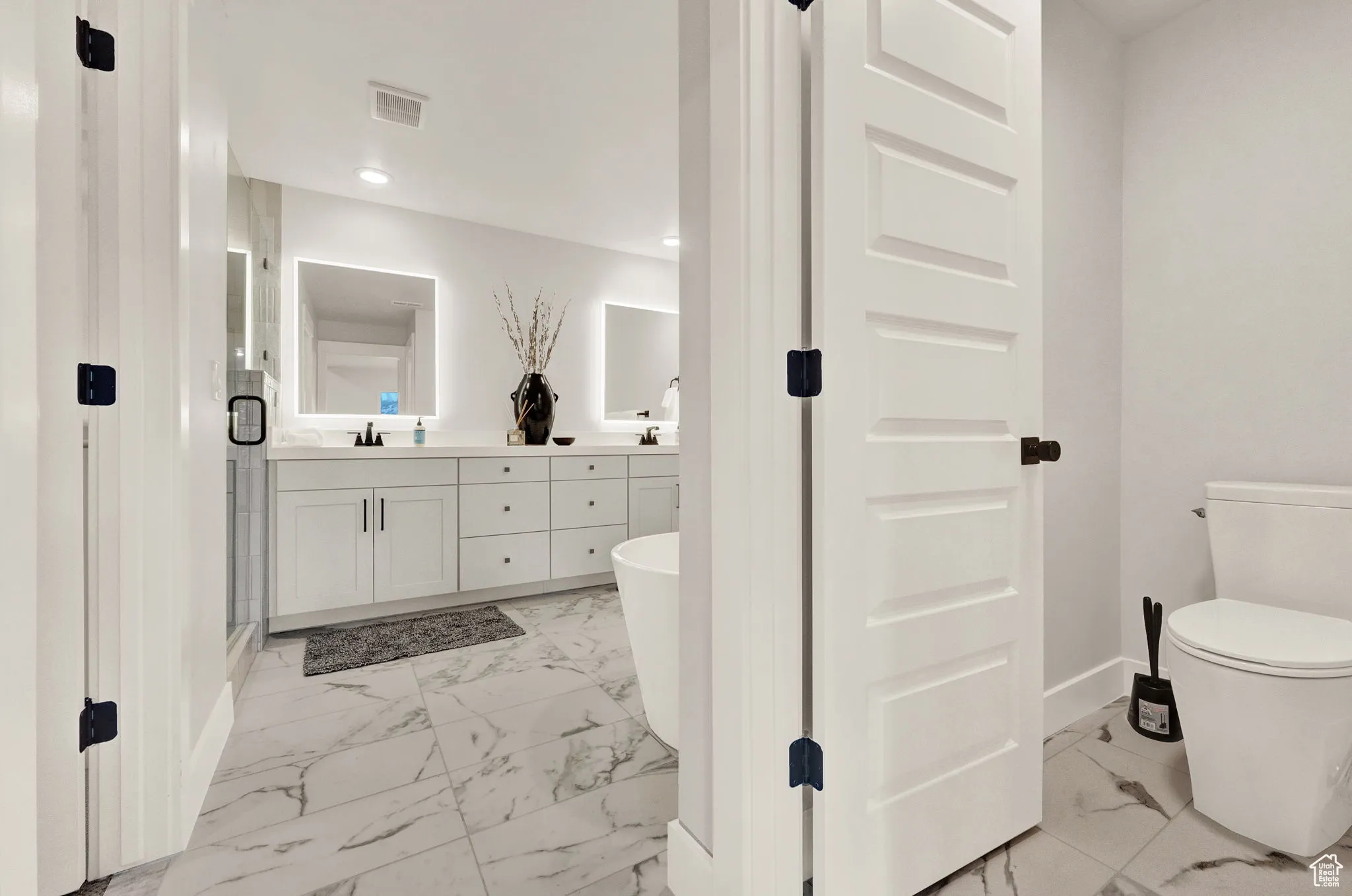 Full bath with marble finish floors, baseboards, double vanity, toilet, and recessed lighting