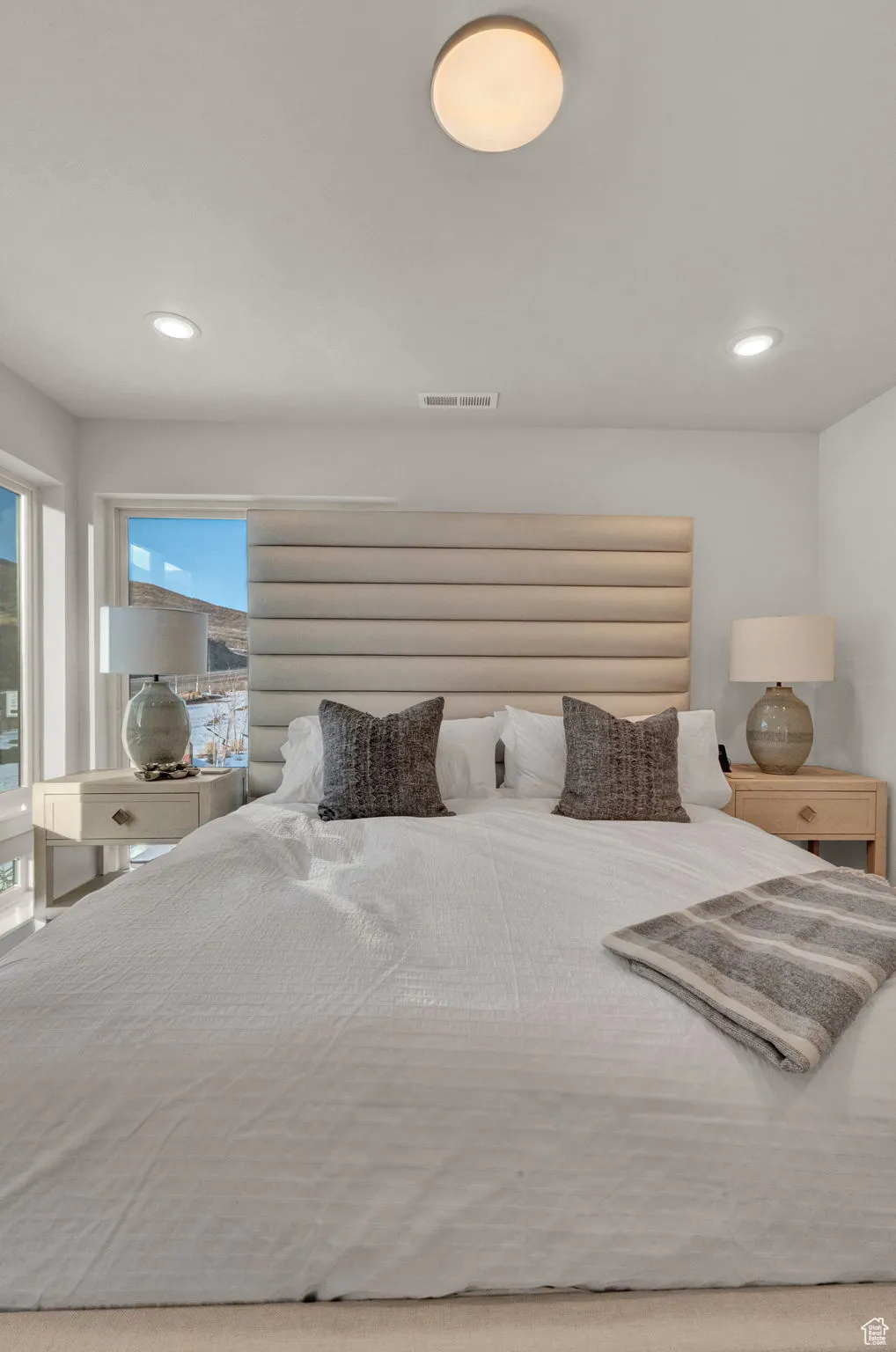 Bedroom featuring multiple windows and recessed lighting