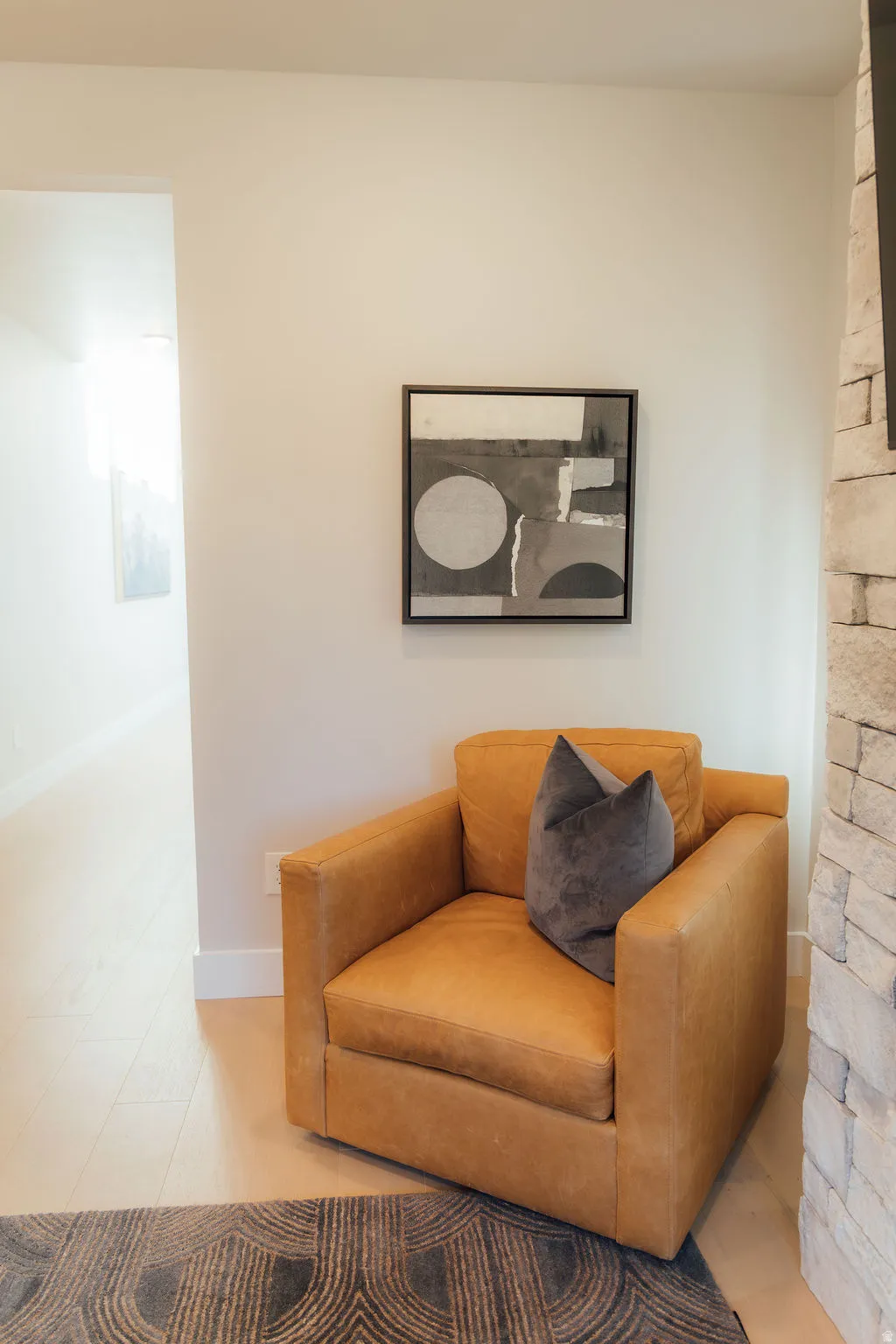 Light wood-finish flooring with white baseboards