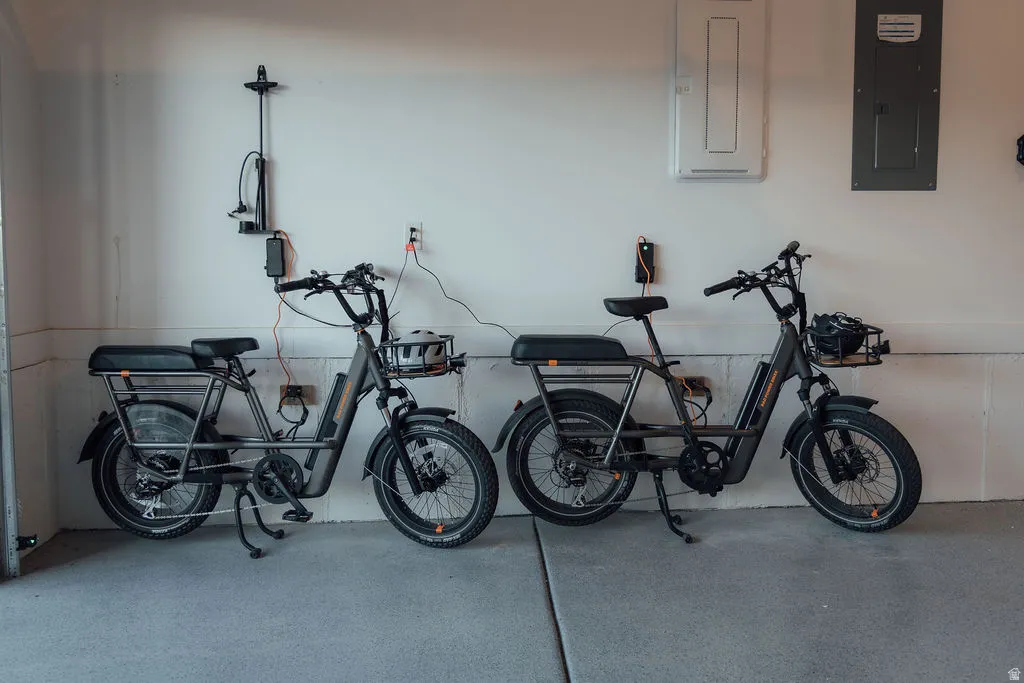 Garage space featuring durable concrete flooring and multiple wall-mounted electrical outlets