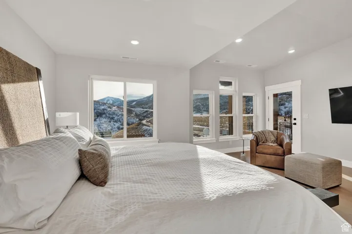 Bedroom featuring baseboards, wood finished floors, and recessed lighting