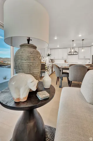 Dining area view of recessed lighting and wall chimney range hood