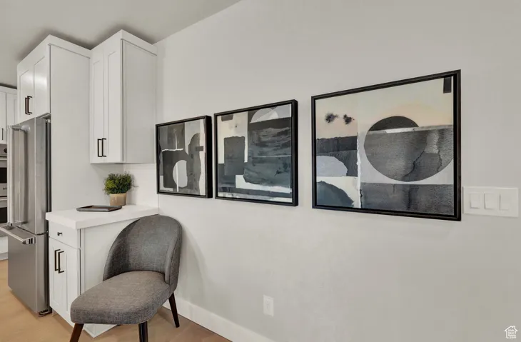 Living area featuring light wood-type flooring and baseboards