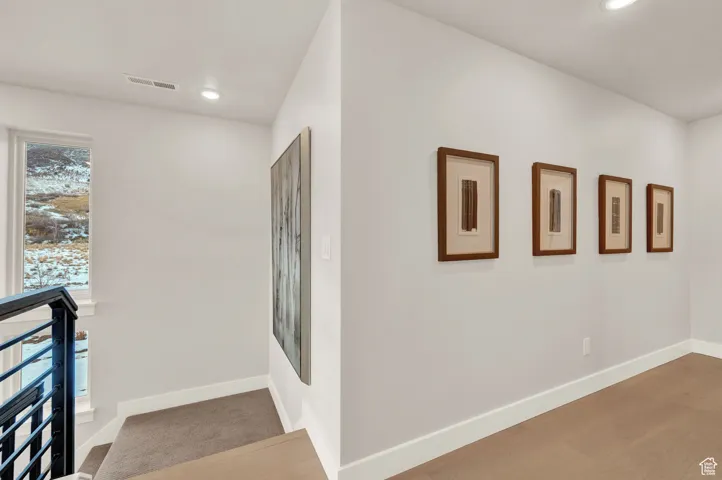 Hallway featuring baseboards and recessed lighting