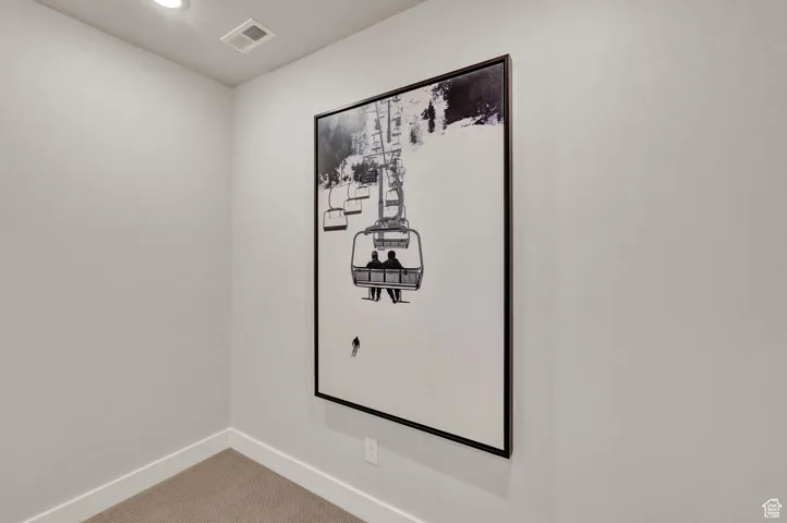 Detailed view of baseboards, carpet flooring, and recessed lighting