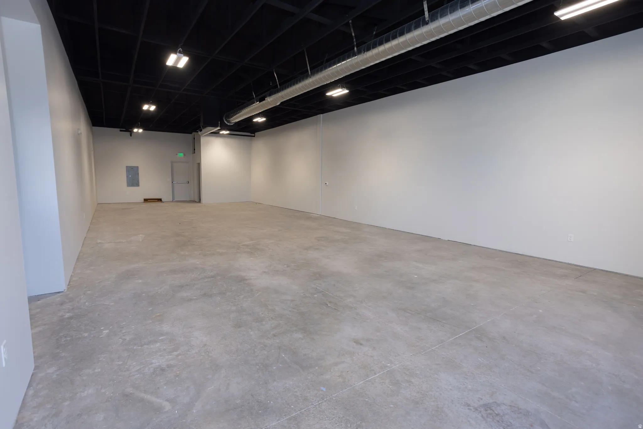 Unfurnished room with concrete flooring