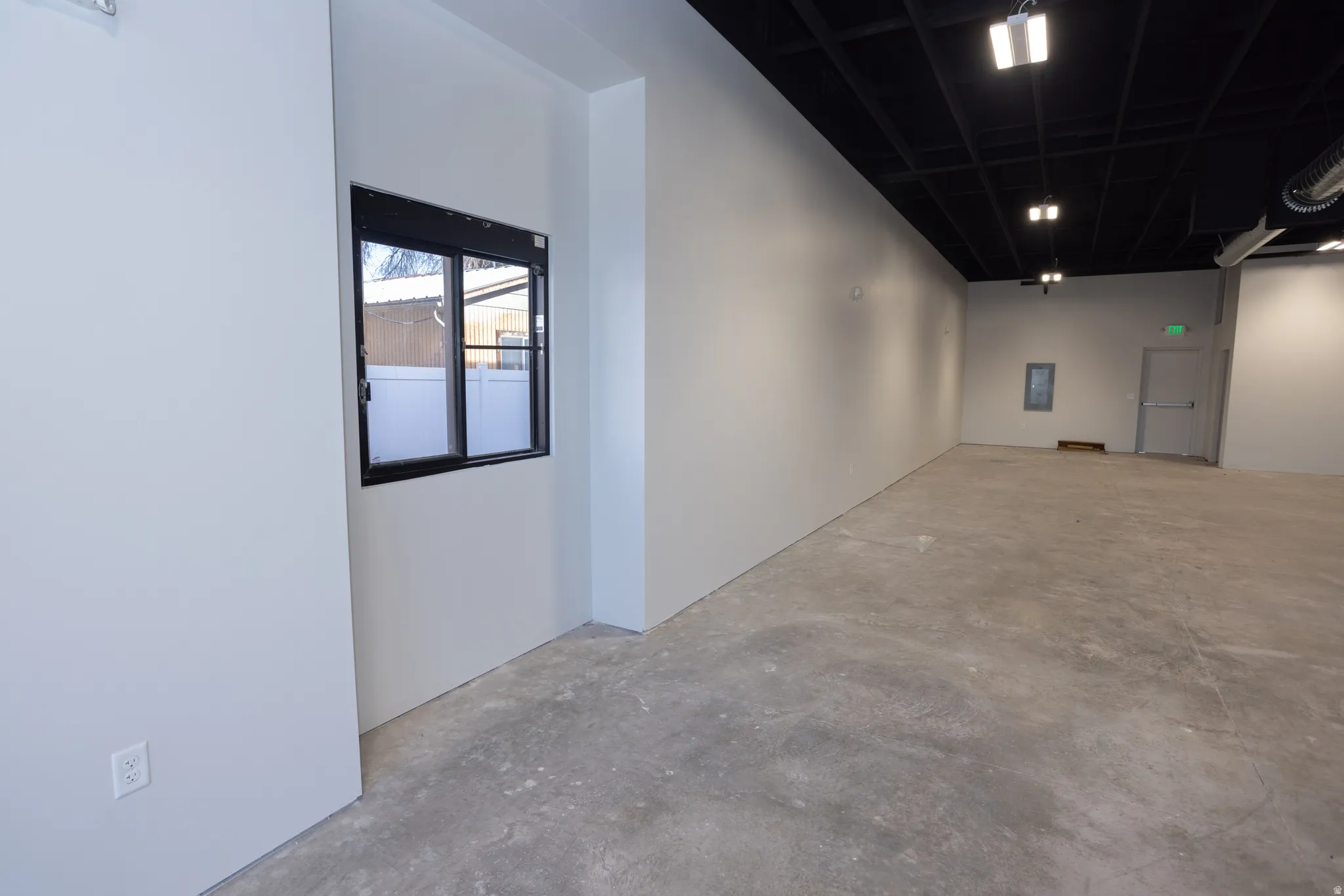 Interior space with unfinished concrete flooring