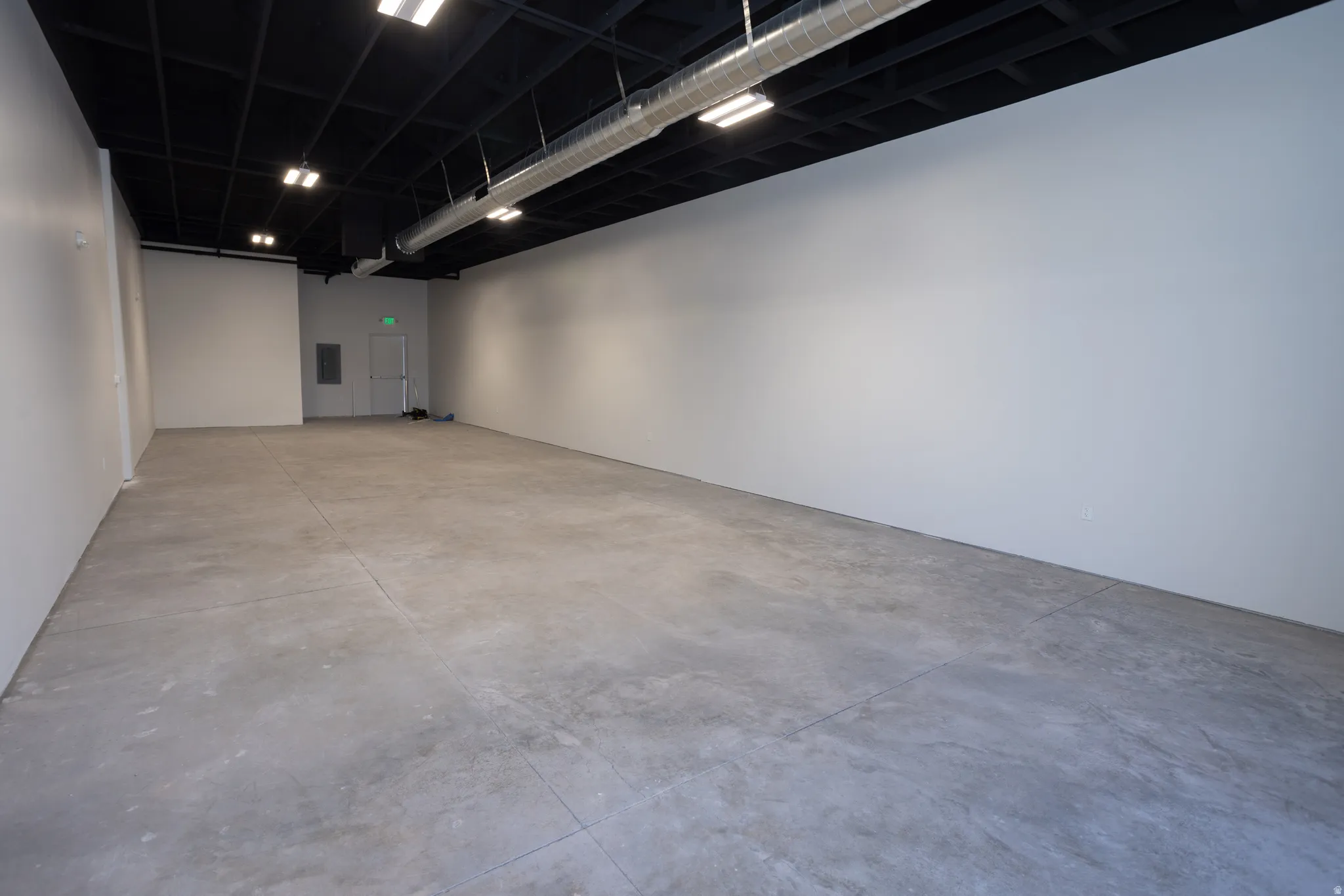 Unfurnished room featuring concrete flooring