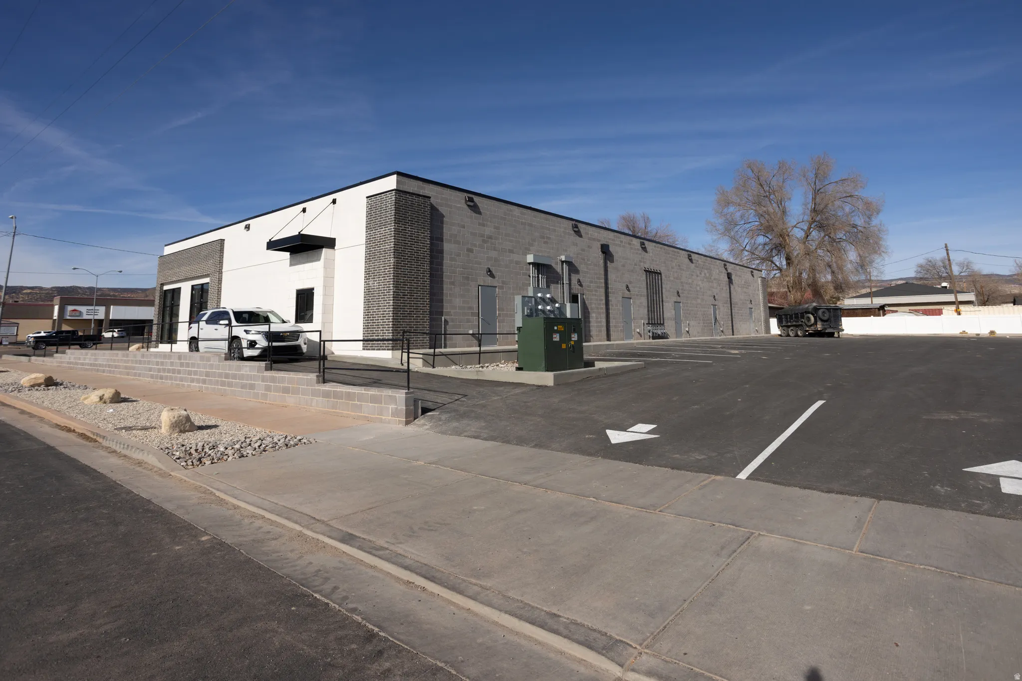 View of building exterior with uncovered parking