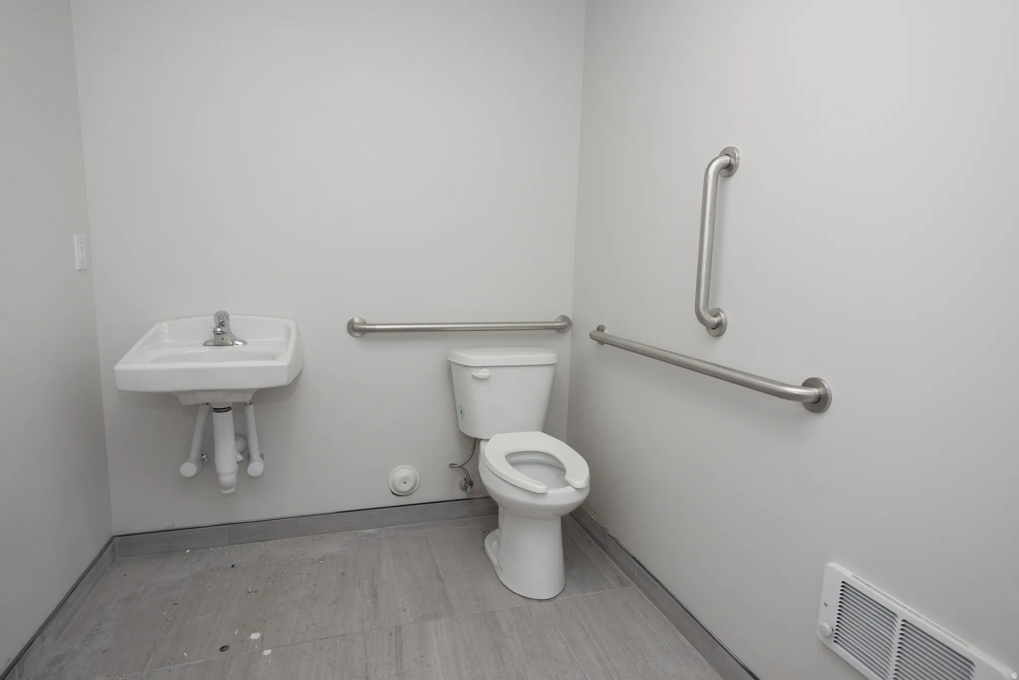 Half bath featuring toilet and baseboards