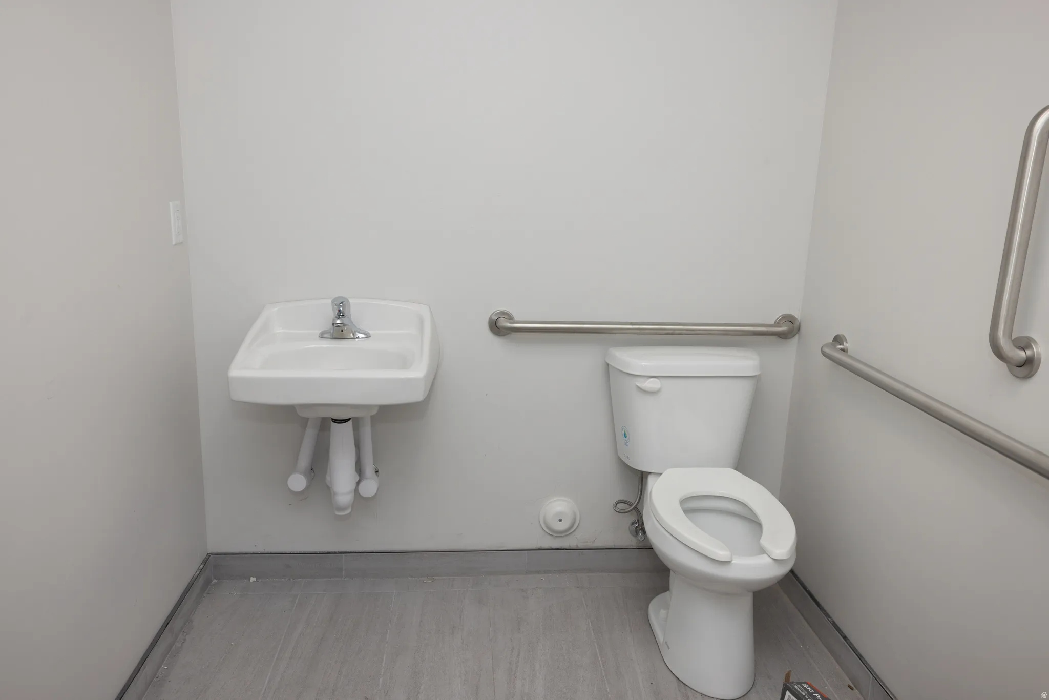 Half bath featuring toilet and baseboards