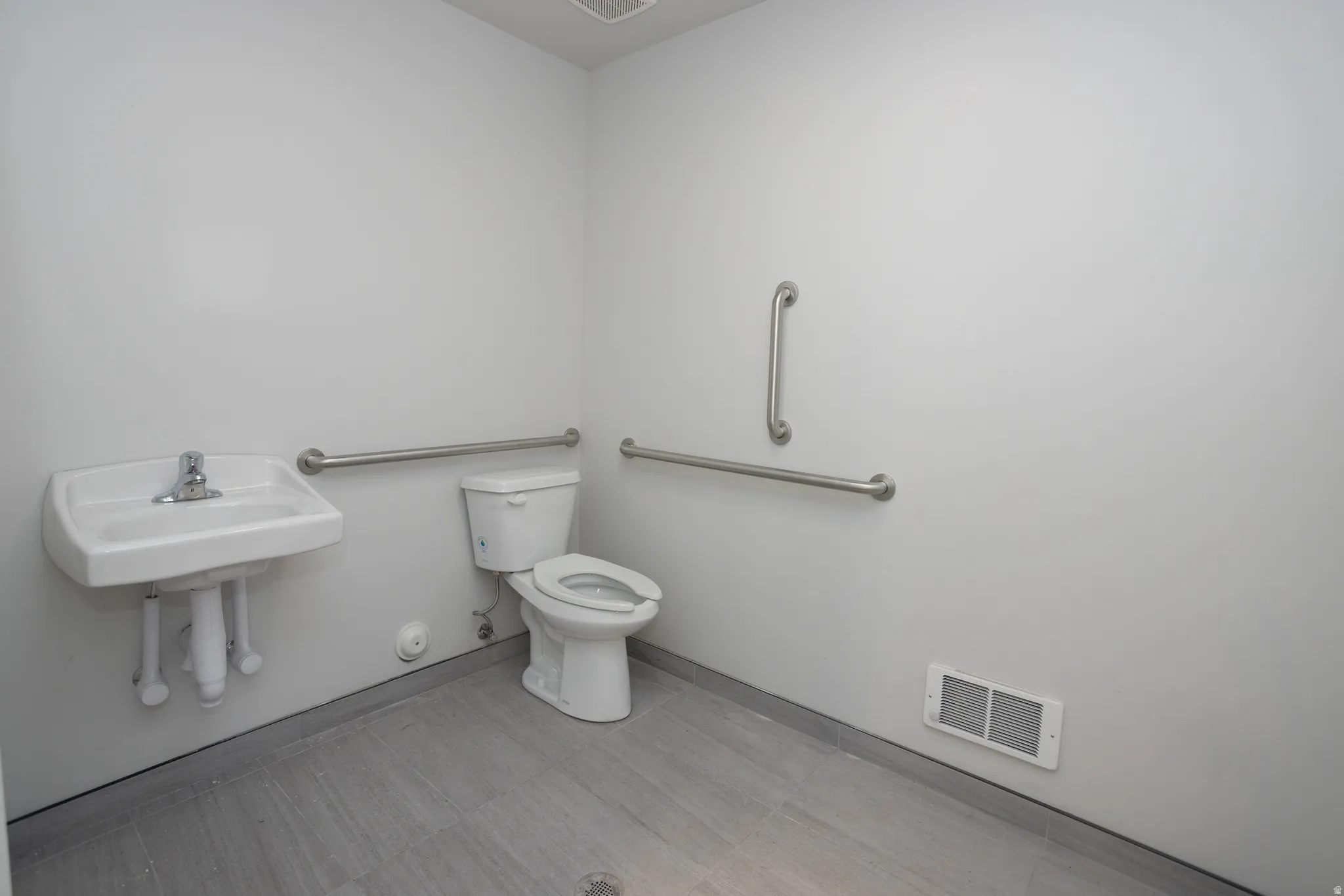 Bathroom featuring toilet and light floors