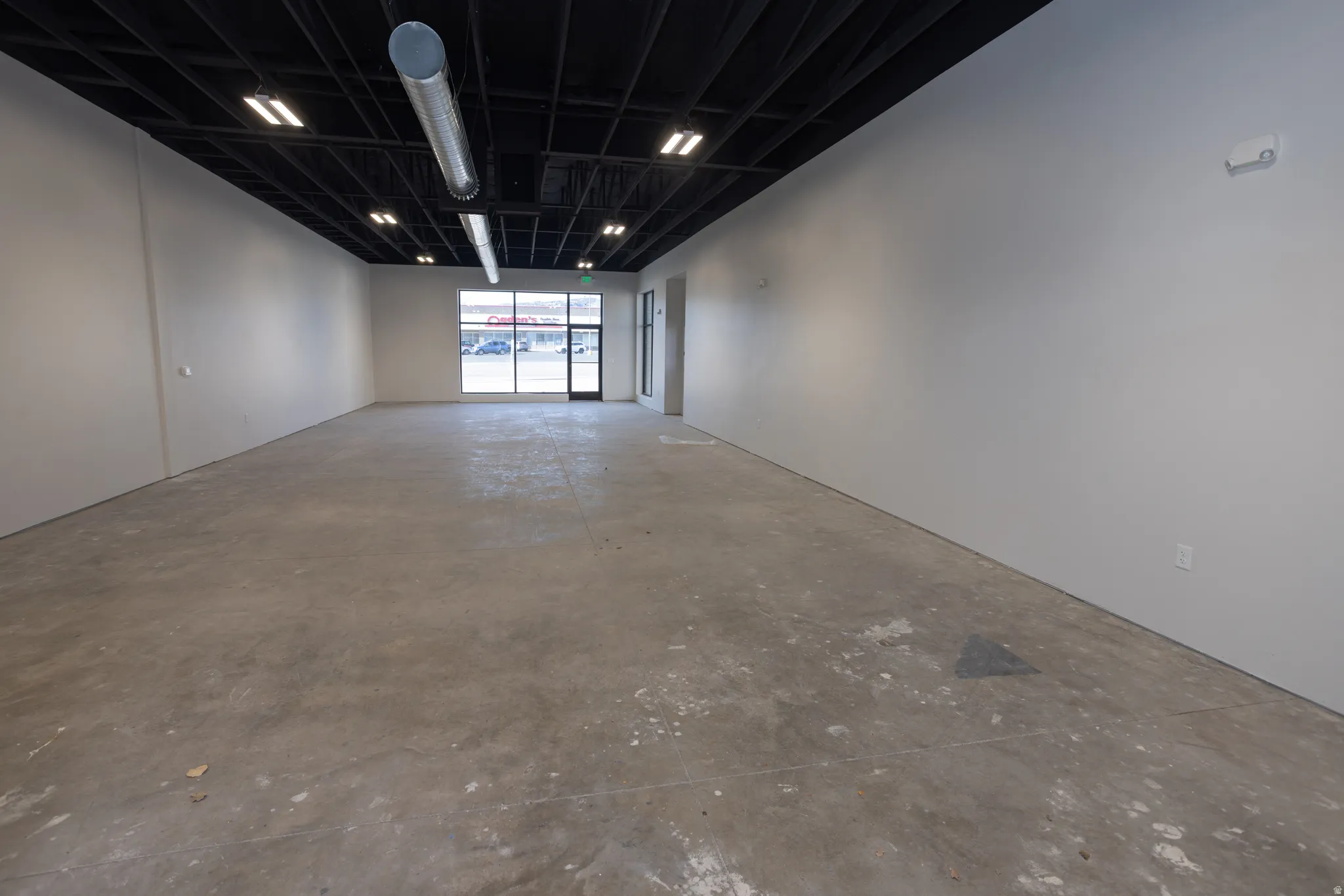 Empty room with unfinished concrete floors