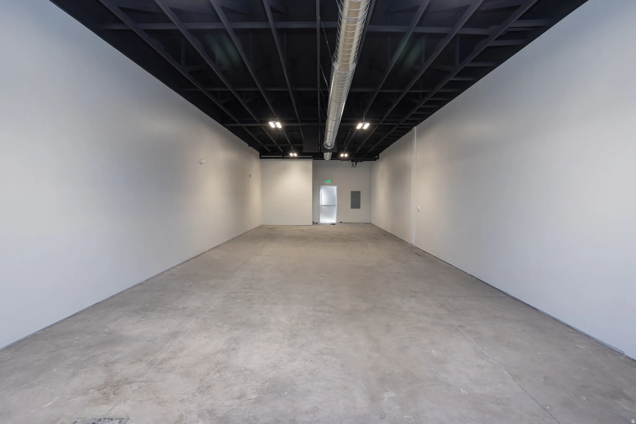 Unfurnished room featuring unfinished concrete floors