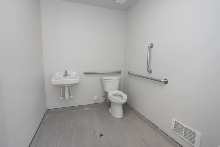 Bathroom featuring toilet and baseboards