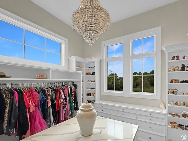 Spacious closet featuring a chandelier