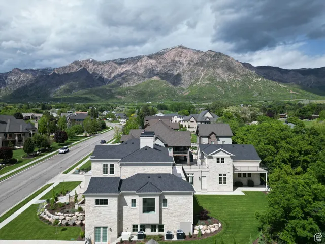 View of mountain backdrop featuring nearby suburban area