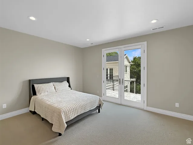 Bedroom featuring light colored carpet, access to exterior, baseboards, recessed lighting, and french doors